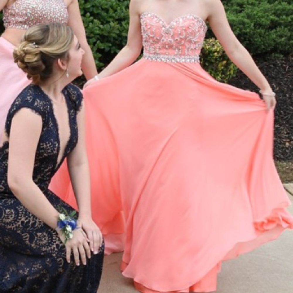 Peach strapless prom dress with structured bodice